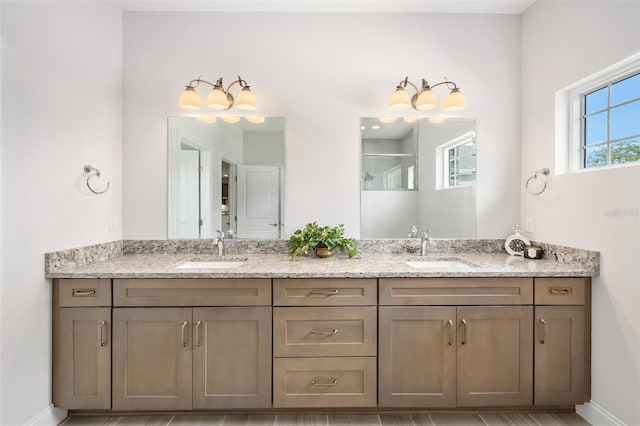 3322 Modena Way, New Smyrna Beach, FL 32168 - bathroom featuring double vanity, baseboards, and a shower