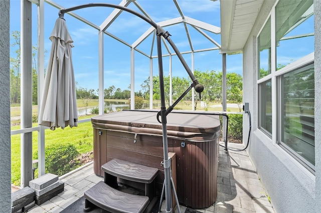 3322 Modena Way, New Smyrna Beach, FL 32168 - view of patio featuring a hot tub, a water view, and glass enclosure