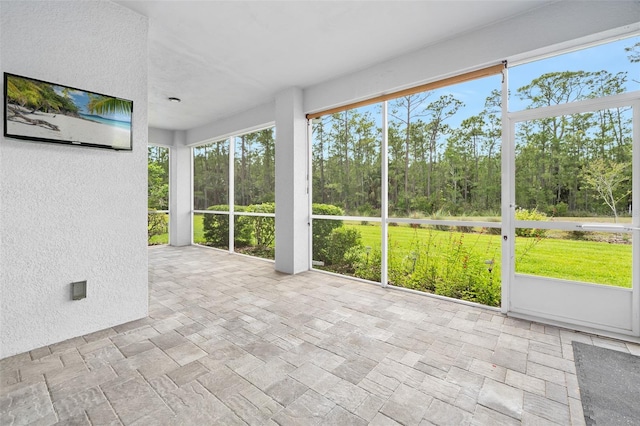 3322 Modena Way, New Smyrna Beach, FL 32168 - unfurnished sunroom with view of scattered trees