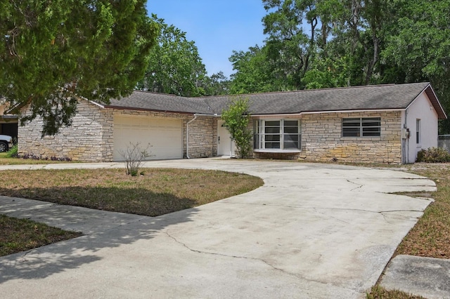 1209 James Ter, Daytona Beach, FL 32117 - view of front of home featuring stone siding, concrete driveway, a garage, and a shingled roof