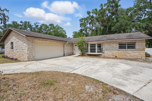 1209 James Ter, Daytona Beach, FL 32117 - view of front of property featuring stone siding, a garage, and concrete driveway