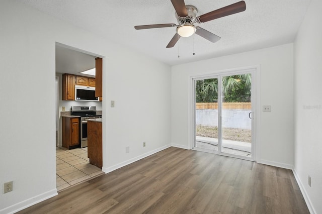 1209 James Ter, Daytona Beach, FL 32117 - empty room with wood finished floors, ceiling fan, and baseboards