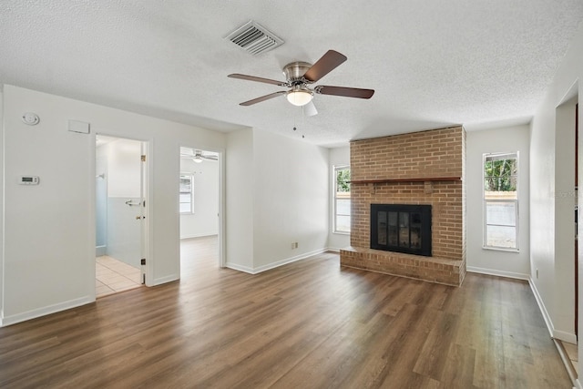1209 James Ter, Daytona Beach, FL 32117 - unfurnished living room with a ceiling fan, a textured ceiling, wood finished floors, and plenty of natural light