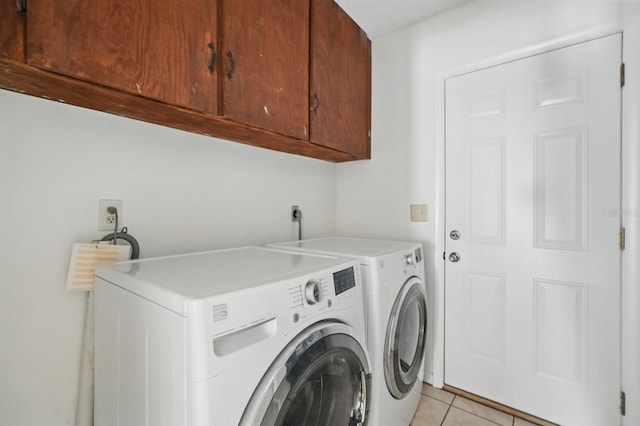 1209 James Ter, Daytona Beach, FL 32117 - laundry area featuring cabinet space, washer and dryer, and light tile patterned flooring