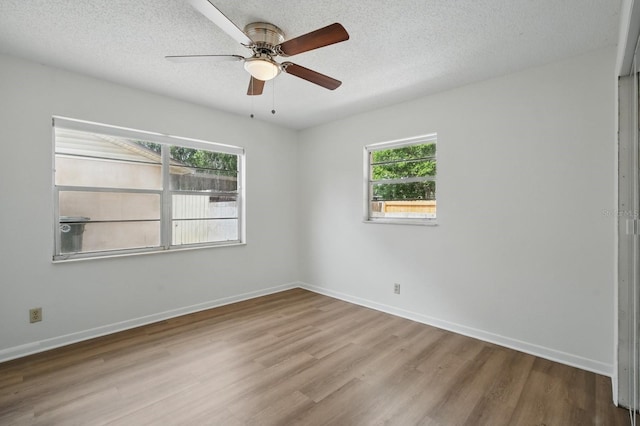 1209 James Ter, Daytona Beach, FL 32117 - spare room featuring wood finished floors, ceiling fan, a textured ceiling, and baseboards