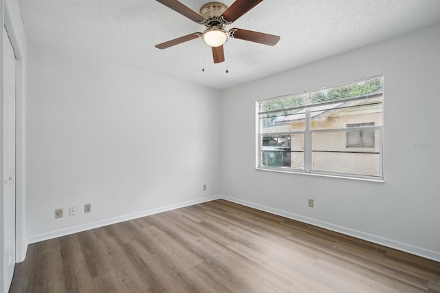 1209 James Ter, Daytona Beach, FL 32117 - empty room featuring wood finished floors, a textured ceiling, baseboards, and a ceiling fan