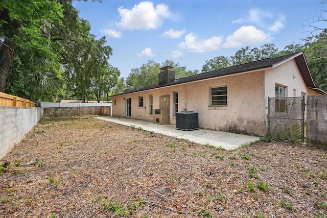 1209 James Ter, Daytona Beach, FL 32117 - rear view of house with central air condition unit, stucco siding, a fenced backyard, and a patio