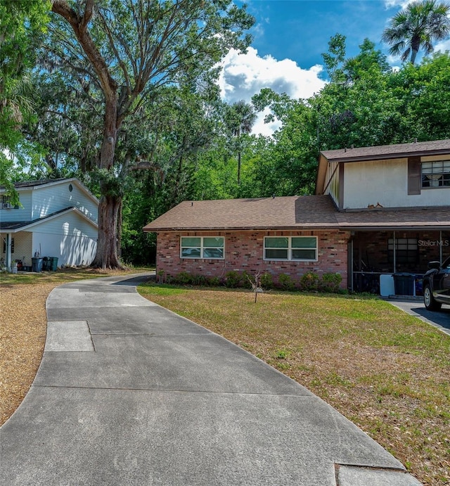 818 Sugar House Blvd, Port Orange, FL 32129 - view of front of property with a front lawn, brick siding, and a shingled roof