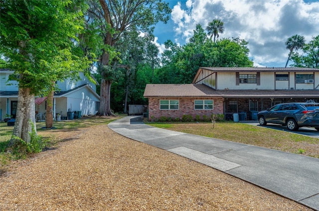818 Sugar House Blvd, Port Orange, FL 32129 - view of front facade with brick siding and a front yard