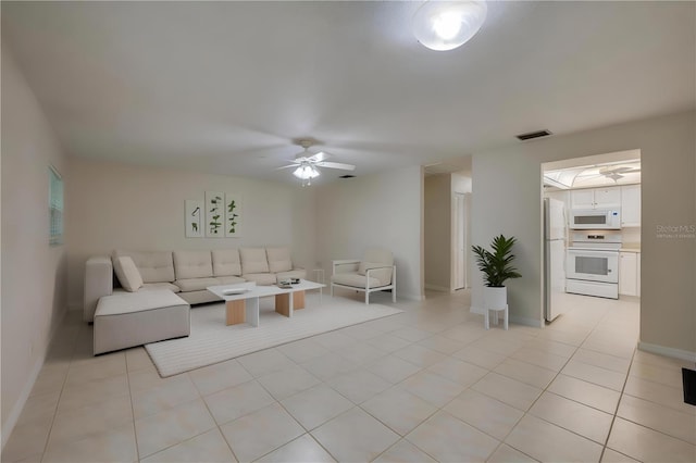 818 Sugar House Blvd, Port Orange, FL 32129 - living area with ceiling fan, light tile patterned floors, and baseboards