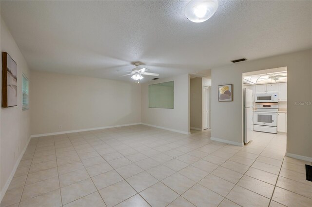 818 Sugar House Blvd, Port Orange, FL 32129 - spare room with ceiling fan, a textured ceiling, light tile patterned flooring, and baseboards