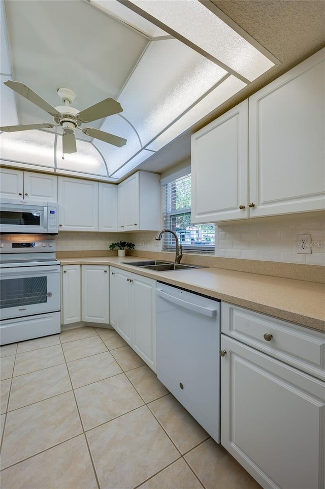 818 Sugar House Blvd, Port Orange, FL 32129 - kitchen with white appliances, a sink, white cabinetry, and light tile patterned floors