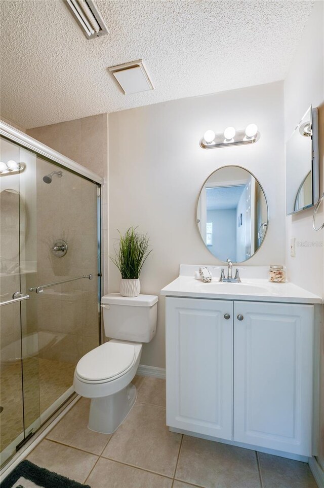 818 Sugar House Blvd, Port Orange, FL 32129 - bathroom featuring a textured ceiling, a stall shower, tile patterned floors, toilet, and vanity