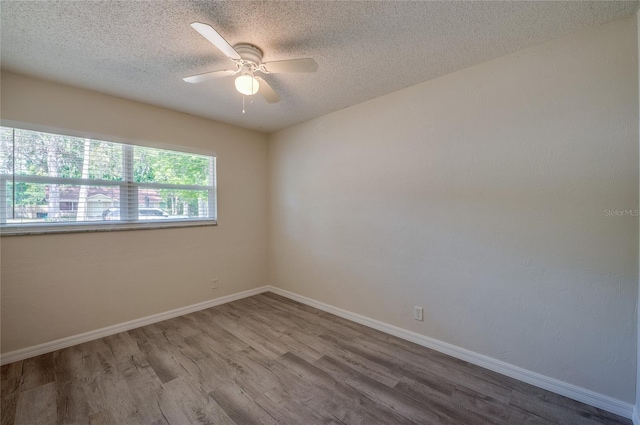 818 Sugar House Blvd, Port Orange, FL 32129 - empty room with wood finished floors, a textured ceiling, ceiling fan, and baseboards