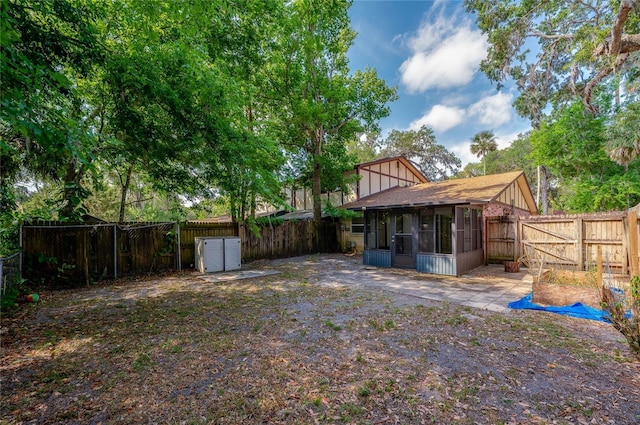 818 Sugar House Blvd, Port Orange, FL 32129 - fenced backyard with a sunroom, a patio area, and a gate