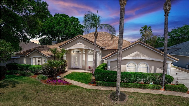 340 Hampton Hills Ct, Debary, FL 32713 - view of front facade featuring a tiled roof, stucco siding, a front yard, and driveway
