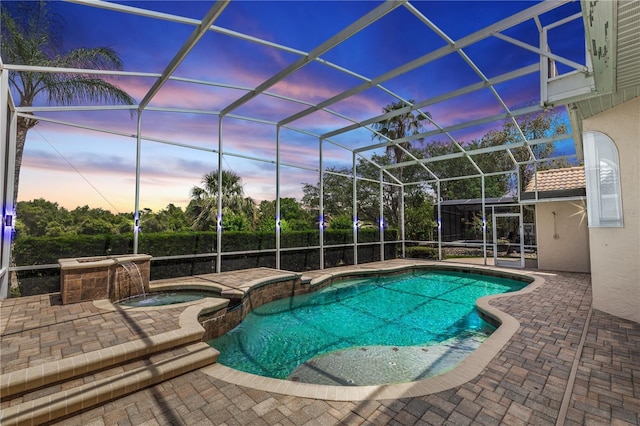 340 Hampton Hills Ct, Debary, FL 32713 - pool at dusk featuring a patio, a pool with connected hot tub, and glass enclosure