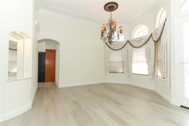 340 Hampton Hills Ct, Debary, FL 32713 - unfurnished dining area featuring arched walkways, wood finished floors, ornamental molding, a chandelier, and baseboards