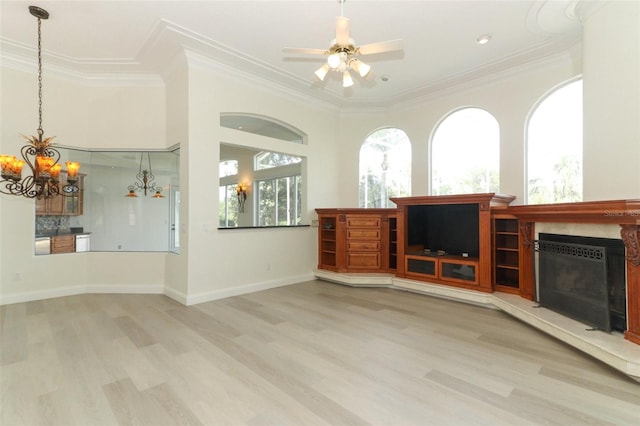 340 Hampton Hills Ct, Debary, FL 32713 - unfurnished living room with a chandelier, wood finished floors, crown molding, a ceiling fan, and a tiled fireplace