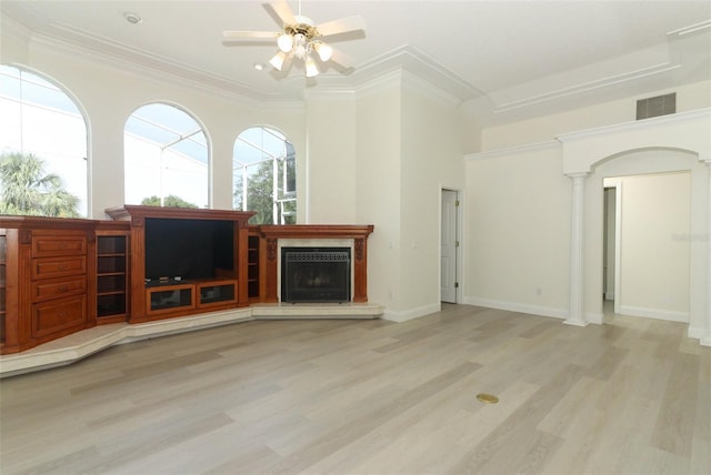 340 Hampton Hills Ct, Debary, FL 32713 - unfurnished living room with ceiling fan, a fireplace with raised hearth, decorative columns, wood finished floors, and crown molding