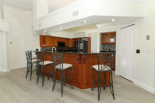 340 Hampton Hills Ct, Debary, FL 32713 - kitchen featuring black appliances, light wood finished floors, decorative backsplash, dark countertops, and recessed lighting