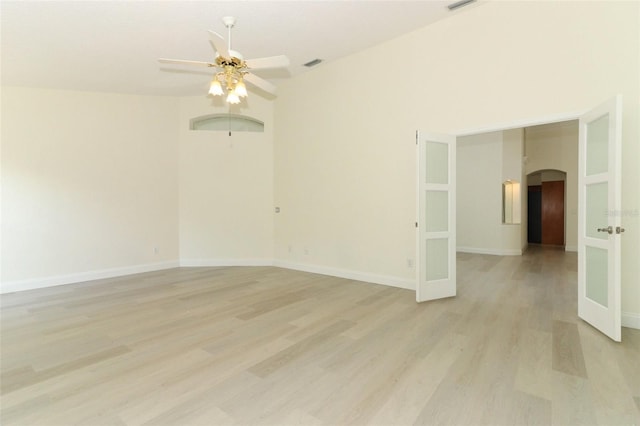 340 Hampton Hills Ct, Debary, FL 32713 - unfurnished room with arched walkways, a ceiling fan, light wood-type flooring, and baseboards