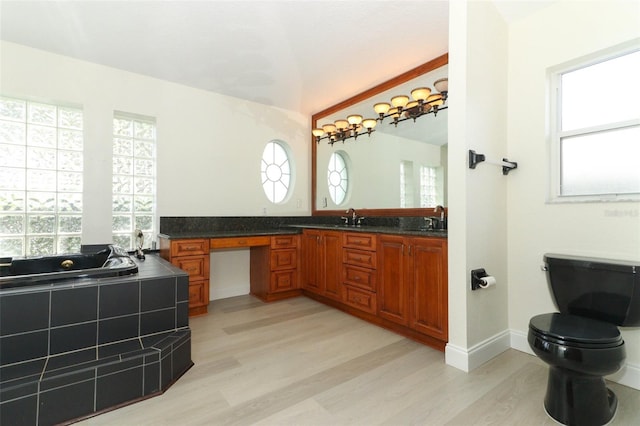 340 Hampton Hills Ct, Debary, FL 32713 - bathroom featuring wood finished floors, vanity, toilet, lofted ceiling, and tiled tub