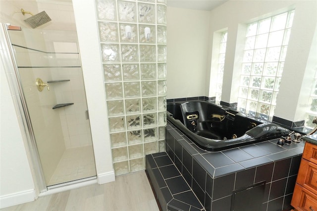 340 Hampton Hills Ct, Debary, FL 32713 - full bathroom featuring walk in shower, a whirlpool tub, and wood finished floors