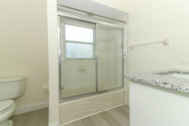 340 Hampton Hills Ct, Debary, FL 32713 - full bath with wood finished floors, toilet, shower / bath combination with glass door, baseboards, and a sink