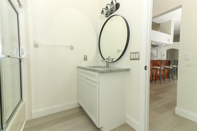 340 Hampton Hills Ct, Debary, FL 32713 - full bathroom featuring wood finished floors, baseboards, combined bath / shower with glass door, and vanity