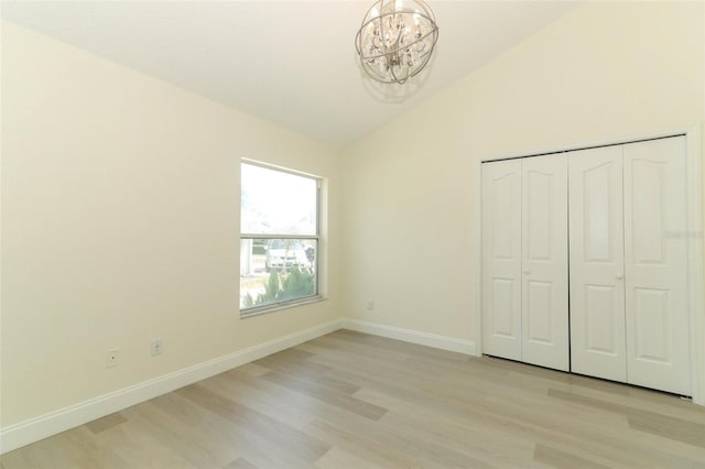 340 Hampton Hills Ct, Debary, FL 32713 - unfurnished bedroom with a chandelier, lofted ceiling, light wood-style flooring, baseboards, and a closet