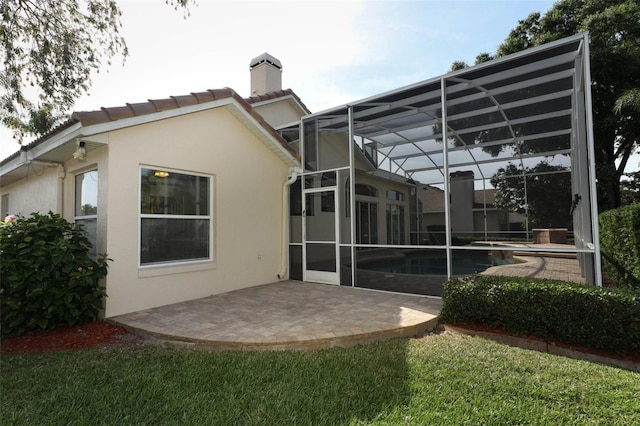 340 Hampton Hills Ct, Debary, FL 32713 - back of house featuring stucco siding, a patio area, a chimney, an outdoor pool, and a lanai