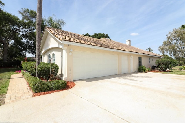 340 Hampton Hills Ct, Debary, FL 32713 - view of home's exterior featuring an attached garage, stucco siding, concrete driveway, and a tile roof