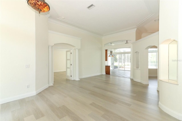 340 Hampton Hills Ct, Debary, FL 32713 - spare room featuring arched walkways, crown molding, decorative columns, light wood-style flooring, and baseboards
