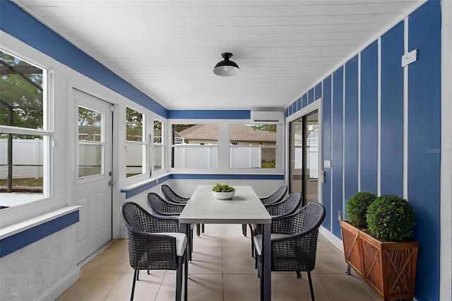 sunroom with outdoor dining area