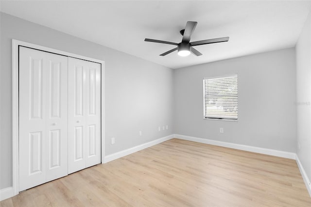 unfurnished bedroom with light wood-style floors, baseboards, a closet, and a ceiling fan