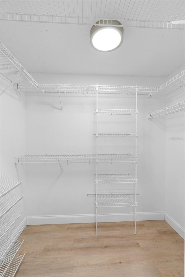 spacious closet with wood finished floors