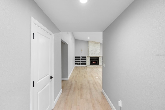 corridor featuring baseboards, light wood-type flooring, and recessed lighting