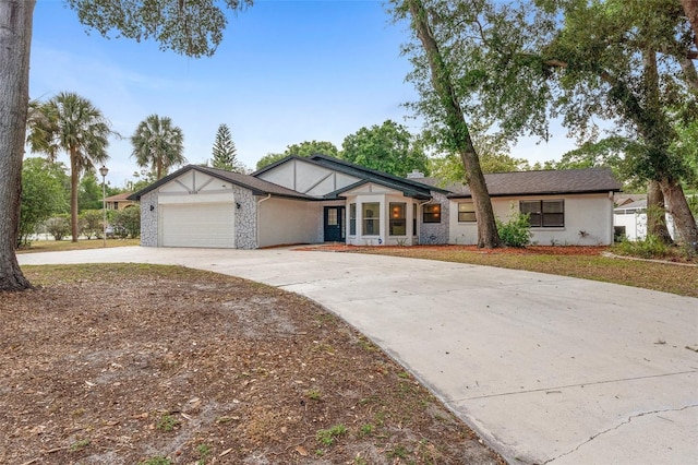 view of front of property featuring driveway, an attached garage, and stucco siding