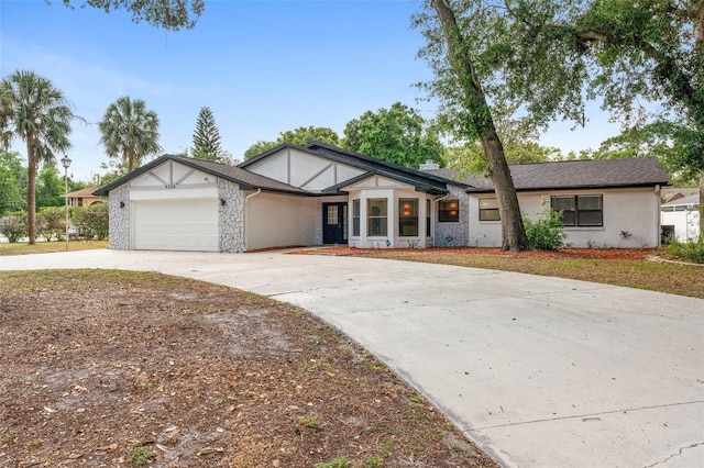 view of front of home featuring concrete driveway, an attached garage, and stucco siding