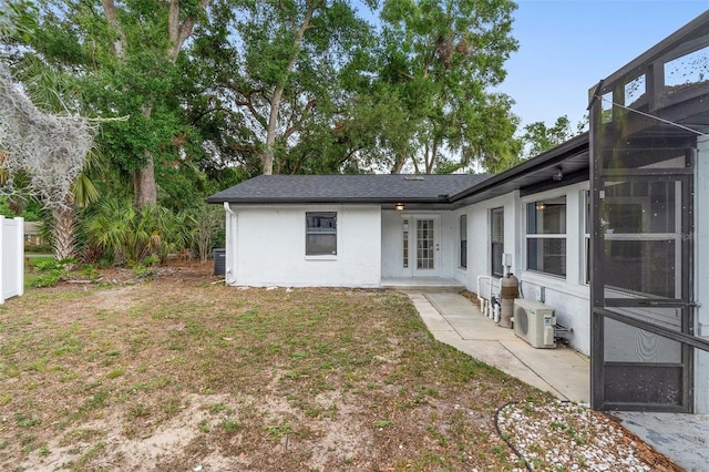 rear view of house featuring stucco siding and a patio