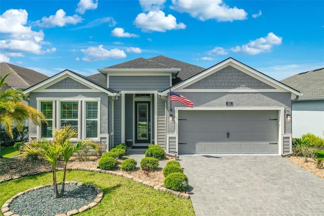 165 Azure Mist Way, Daytona Beach, FL 32124 - view of front of property featuring an attached garage, decorative driveway, a front yard, and a shingled roof