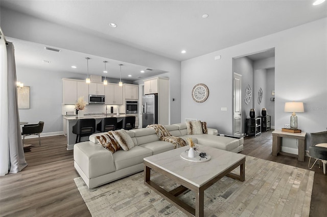 165 Azure Mist Way, Daytona Beach, FL 32124 - living area featuring light wood-style floors, recessed lighting, and baseboards