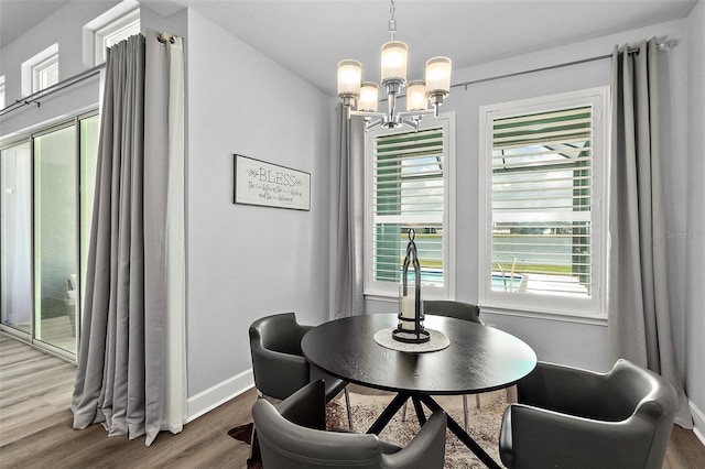 165 Azure Mist Way, Daytona Beach, FL 32124 - dining room featuring a chandelier, wood finished floors, and plenty of natural light