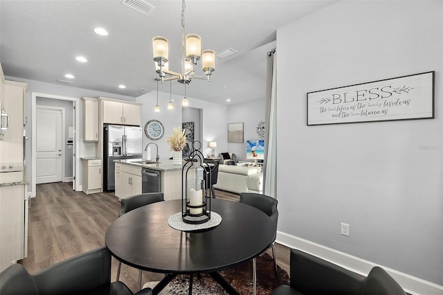 165 Azure Mist Way, Daytona Beach, FL 32124 - dining space featuring a chandelier, dark wood-style flooring, and recessed lighting