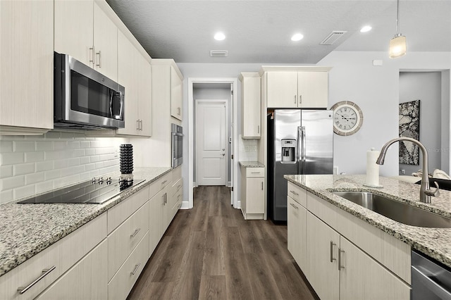 165 Azure Mist Way, Daytona Beach, FL 32124 - kitchen with stainless steel appliances, a sink, decorative backsplash, dark wood finished floors, and pendant lighting
