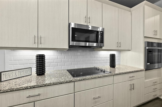 165 Azure Mist Way, Daytona Beach, FL 32124 - kitchen featuring appliances with stainless steel finishes, tasteful backsplash, and light stone counters