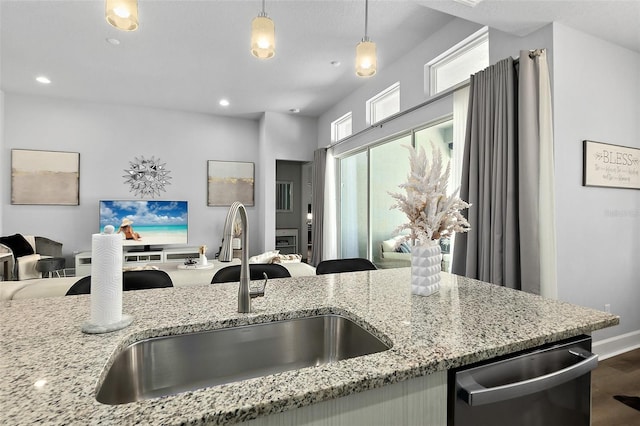 165 Azure Mist Way, Daytona Beach, FL 32124 - kitchen featuring stainless steel dishwasher, a sink, open floor plan, pendant lighting, and light stone countertops