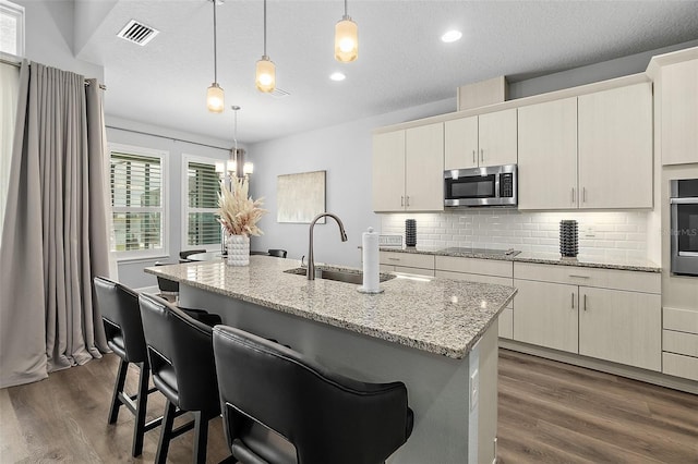 165 Azure Mist Way, Daytona Beach, FL 32124 - kitchen featuring a sink, appliances with stainless steel finishes, dark wood-style flooring, tasteful backsplash, and decorative light fixtures