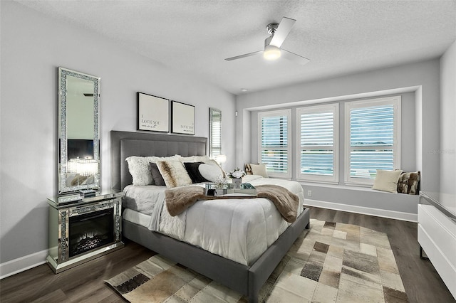 165 Azure Mist Way, Daytona Beach, FL 32124 - bedroom featuring multiple windows, wood finished floors, a textured ceiling, baseboards, and a ceiling fan
